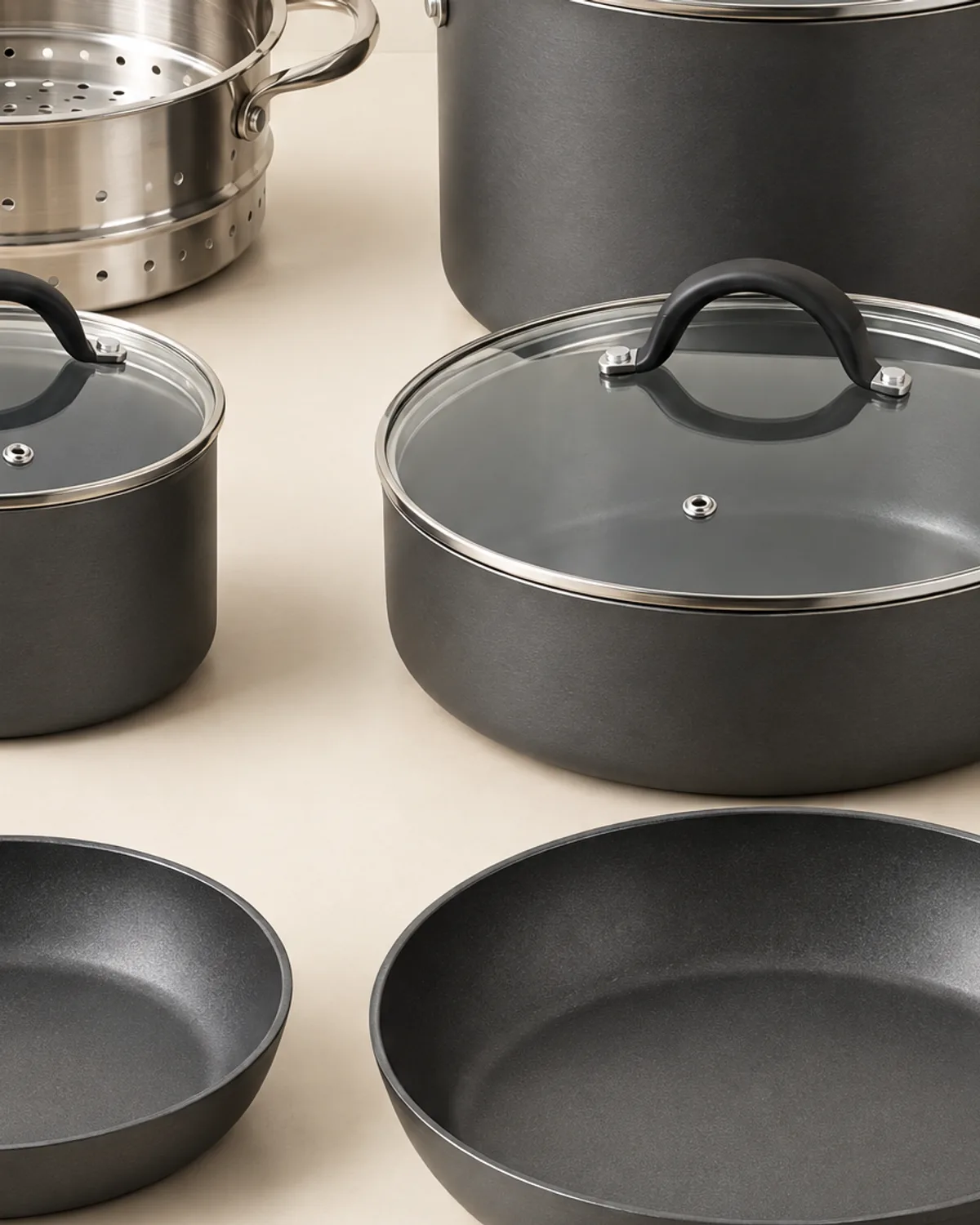 Close-up of charcoal nonstick pans and glass lids